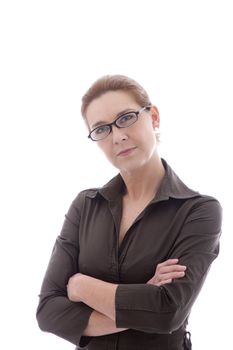 Woman wearing glasses standing with her arms folded looking at the viewer with an intent look, isolated on white