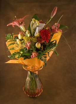 Beautiful bouquet of fresh flowers in the brown background