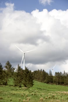 windmills on the hills of Glenough in county Tipperary Ireland with trees and fields in foreground