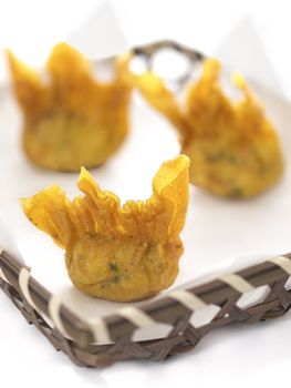 close up of a basket of fried wantons