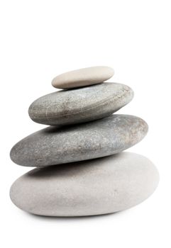 Stack of four round stones isolated over white background