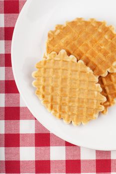 Golden round waffles on a white plate