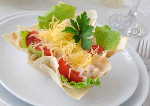 Chicken with tomatoes and cheese in a basket made of dough "phyllo"