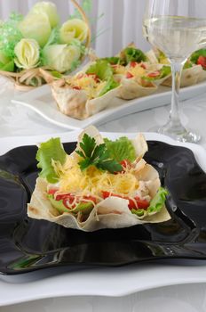 Chicken with tomatoes and cheese in a basket made of dough "phyllo"