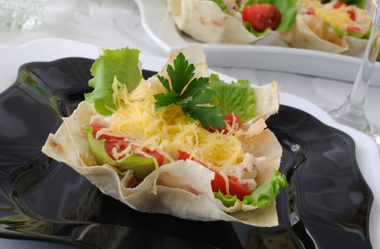 Chicken with tomatoes and cheese in a basket made of dough "phyllo"