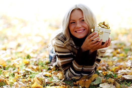 woman take autumn gift in park