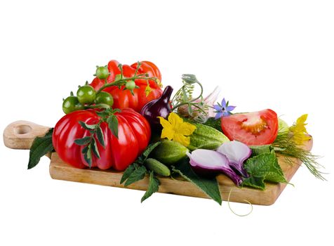 tomatoes, cucumbers and onions on a wooden board