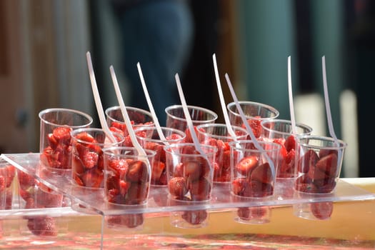 Strawberries in plastic cup for sale