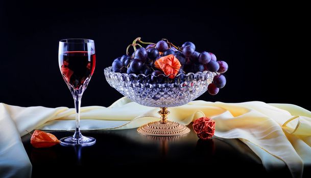 Still life with red wine and grapes