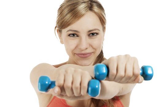 cute fitness woman exercising with blue dumbbells on white background