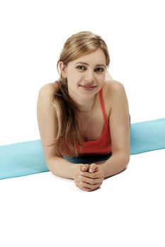 cute smiling fitness woman making a break on her mat on white background