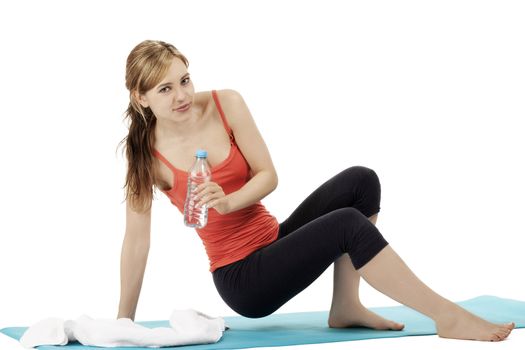 young blonde fitness woman about to sit for a break on white background