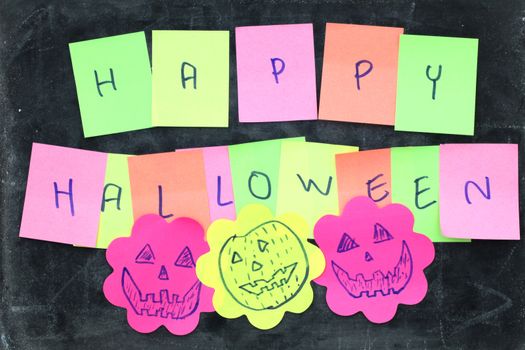 Happy halloween made from memo stick paper craft on blackboard