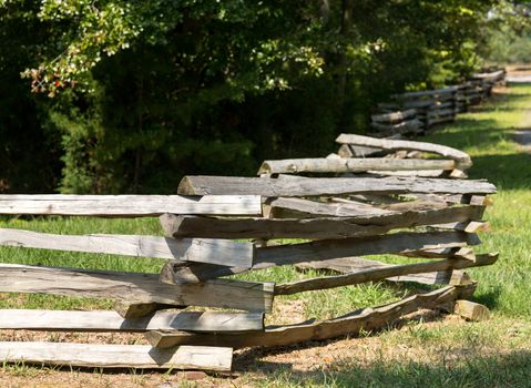 Traditional split rail fence by side of woods or forest