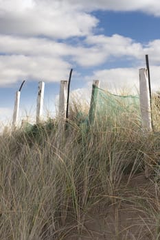 wooden fence on the top of sand dunes in county Donegal, Ireland