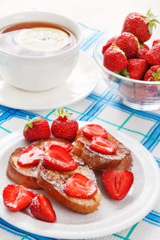 French toasts with powdered sugar and a strawberry