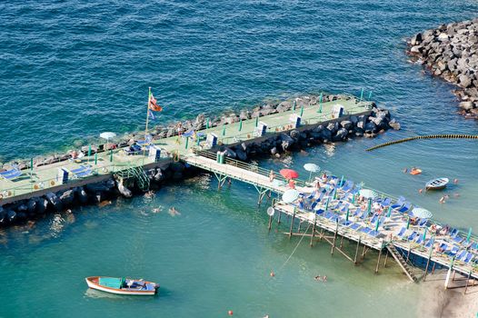 Sunbathing on a pier in the gulf of naples, italy