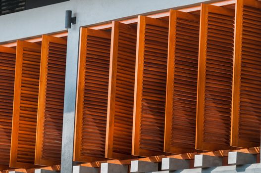 Wall with open wooden window shutters