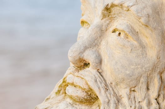 Face of mythological god Neptune with water on background