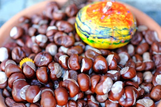 Chestnuts and pumpkin in a bowl.