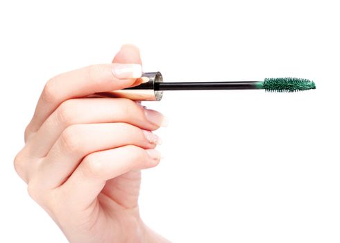 Mascara in woman's hand, isolated on white