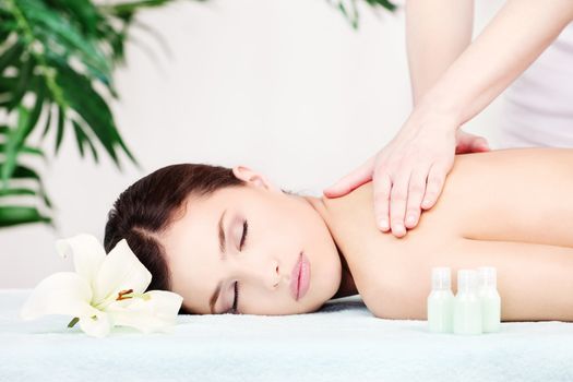 Pretty woman on shoulder massage in salon