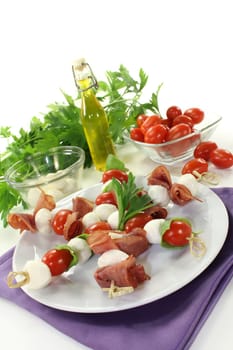 skewers with mozzarella, tomato, basil and ham