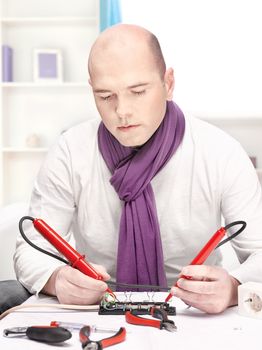 man repair an extension cord at home