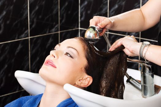 Hairdresser rinse customers hair in salon