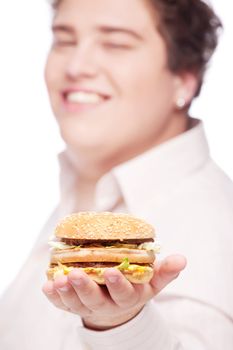 hamburger in hand of a young chubby man, isolated on white