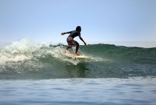 Man-surfer in ocean. Bali. Indonesia