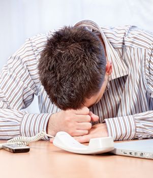 Desperate young business man in office