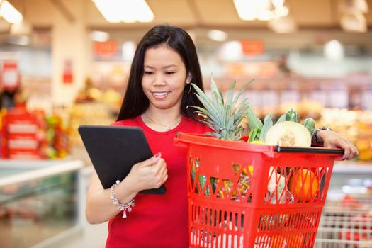 Smiling woman looking at digital tablet