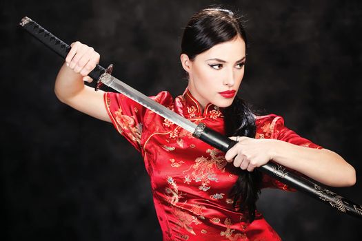 beautiful girl dressed in a kimono with katana in her hands