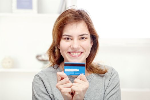 Happy young woman can on line shopping with credit card