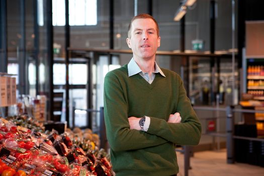 a portrait of a man in a supermarket