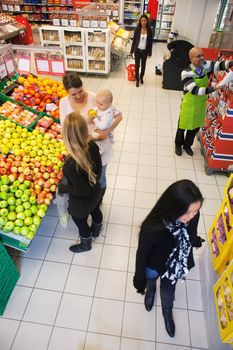 High angle view of people buying in supermarket