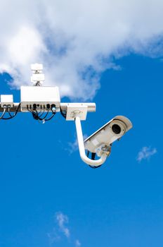 Surveillance camera on blue sky bacgroung