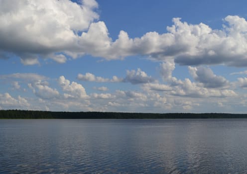 White clouds over lake water in the summer