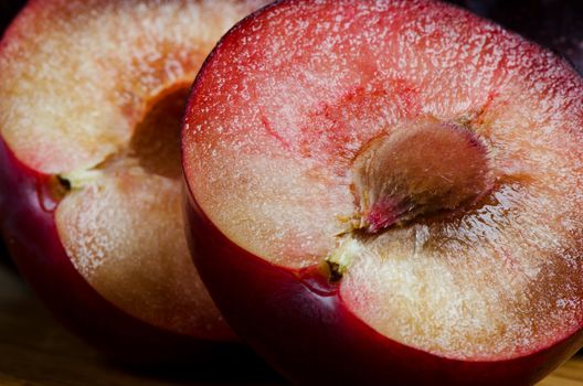 Cut plum on  wooden board