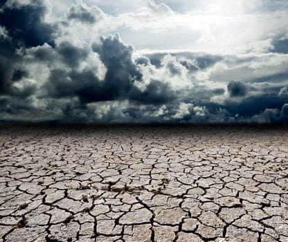 Landscape with storm clouds and dry soil