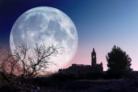 Mysterious landscape with full moon and church