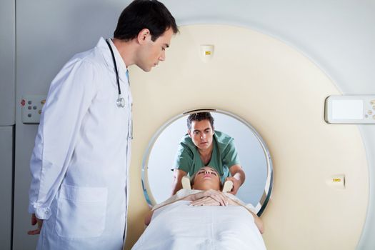 Doctor assisting the MRI scan with the technician in the laboratory