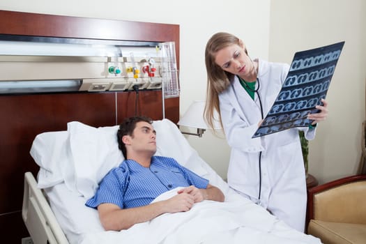 Female doctor showing chest x-ray report to a male patient