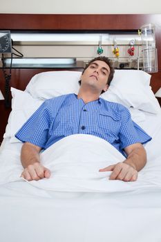 An severe male patient at hospital bed