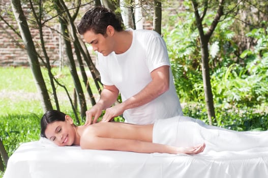 Young woman getting a massage by a handsome man