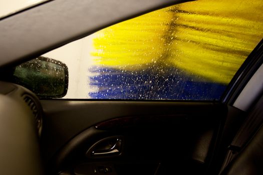 An automatic car wash brush, washing the side of a car