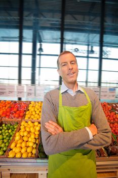 Portrait of a happy supermarket owner looking at the camera