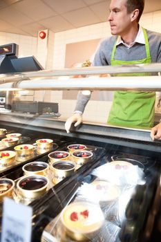 Pastry for selling in the supermarket with market assistant in the background