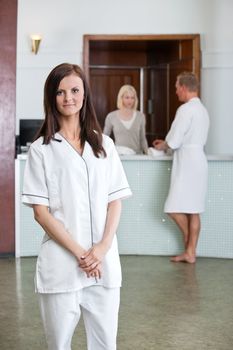 Young Caucasian woman with people in background at spa centre